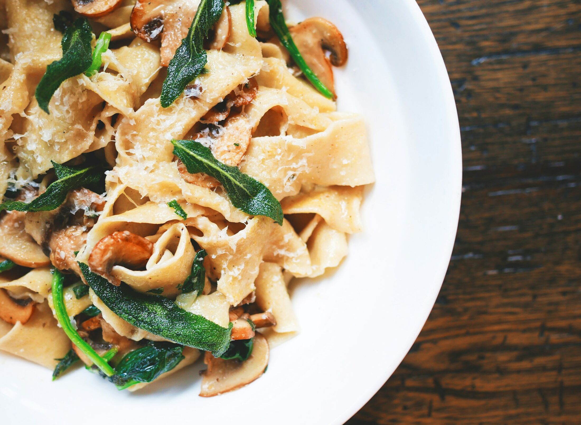 Ribbons of fresh pasta with greens and mushrooms